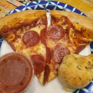 a slice of pepperoni pizza and a biscuit