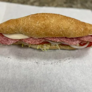 a sub sandwich with meat and cheese