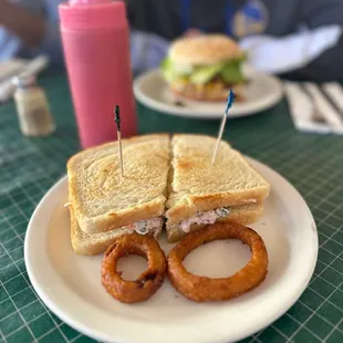 a sandwich and onion rings on a plate