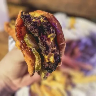 a hand holding a sandwich