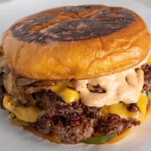 a hamburger with cheese and onions