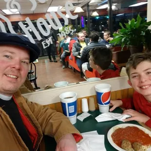 a man and a boy sitting at a table