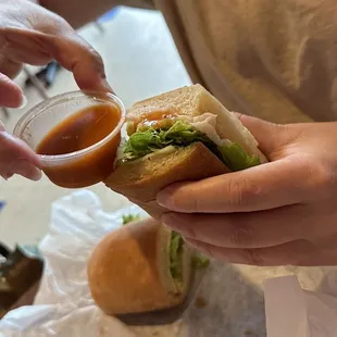 a person holding a sandwich