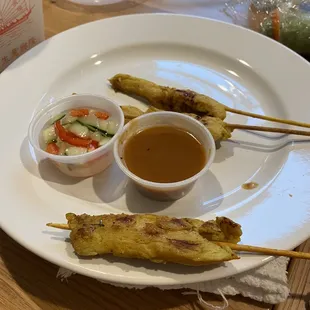 Skewer with a piece of metal on it