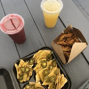 Berry smoothie and nachos topped with vegan cheese and jalapeños.  Fried mushrooms and a mint, ginger sea moss drink.