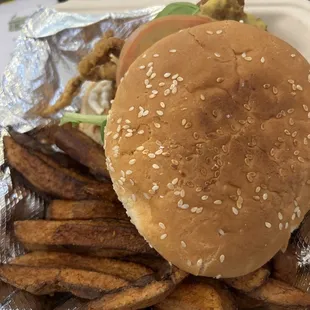 a hamburger and fries in a styrofoam container