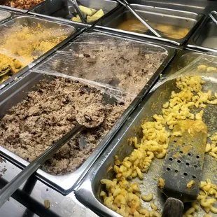 several trays of food being prepared