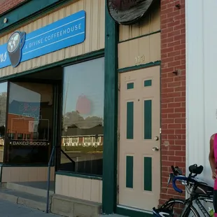 a woman standing next to a bicycle