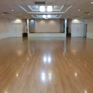 View towards the stage, complete with projector system and a drop down screen on the stage.