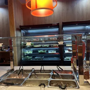 Self serve area for seafood, veggies, mushrooms, noodles, etc