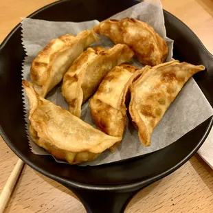 a plate of dumplings in a frying pan