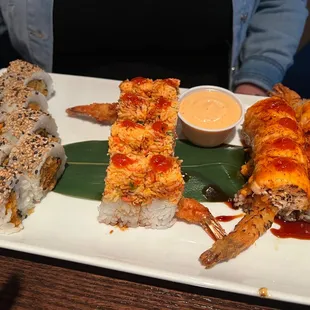 Left to right: Sweet Potato Tempura Roll, Chili Shrimp Roll, Smokey Dragon* with a side of Spicy Mayo