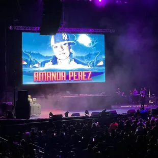 a large screen with a picture of a man on it