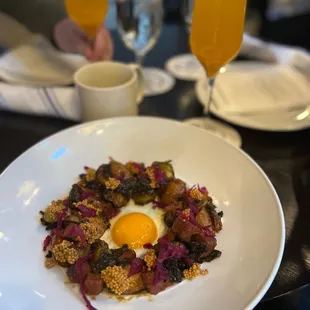 a plate of food and a glass of orange juice