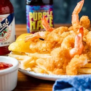 a plate of deep fried shrimp and fries