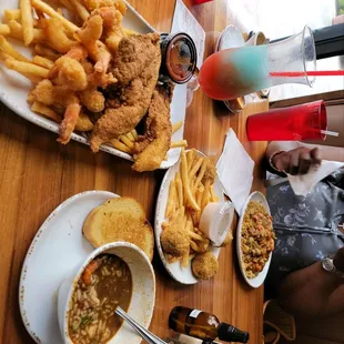 Shrimp and cat fish platter, gumbo, ettufqee on a bed of dirty rice, boudin balls, with community lemonade  and house daiquiri.