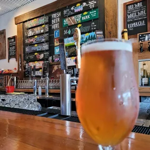 a glass of beer on a bar