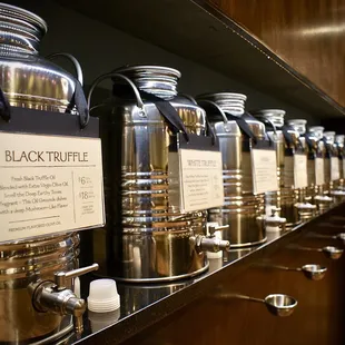 a row of coffee pots on a shelf