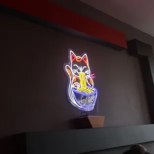 a neon sign of a cat