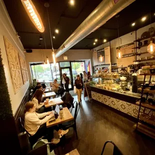 people sitting at tables in a cafe