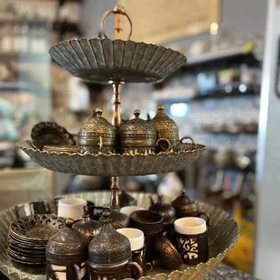 a three tiered tray with cups and saucers