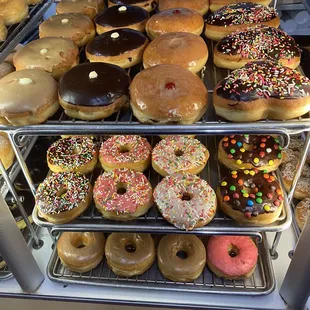 a variety of donuts in a display case