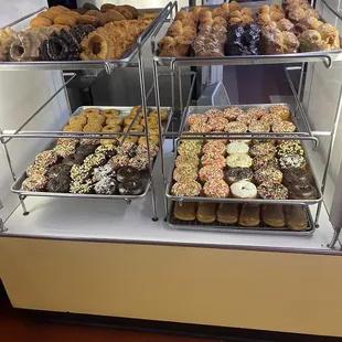a variety of donuts in a display case