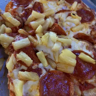 a pizza with pineapples and pepperoni
