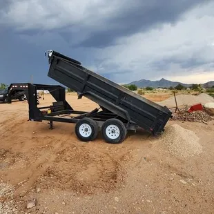a dump trailer on a dirt road