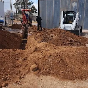 a bulldozer digging a pile of dirt
