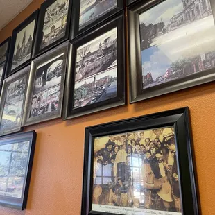 a wall of framed pictures