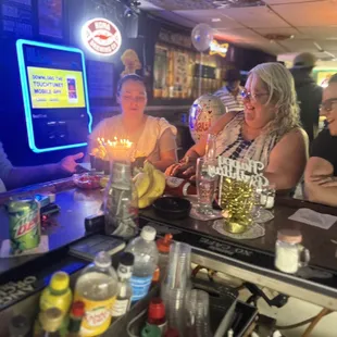 a group of people sitting at a bar