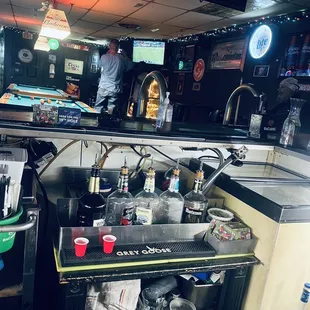 a bar with a bar counter and a man in the background