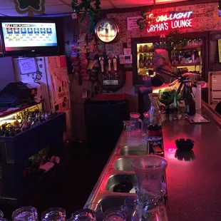 a bar with wine glasses on the counter