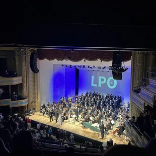 a large orchestra performing on stage