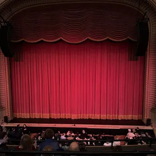 a stage with a red curtain