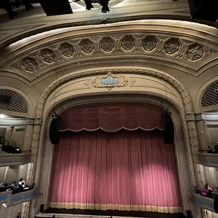 a stage with a red curtain