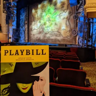 a hand holding a playbill