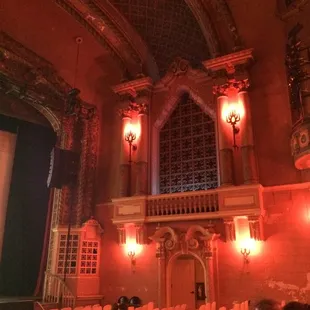 people sitting in chairs in front of a screen