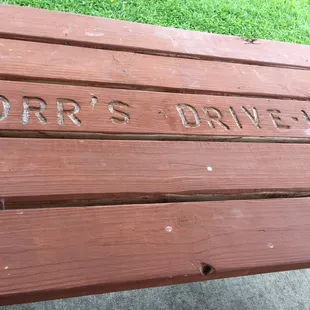 a wooden bench with the words orr&apos;s drive in engraved on it