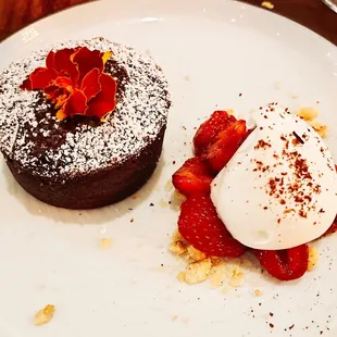 chocolate clafoutis w/ berry compote and chantilly cream