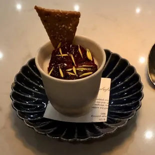 a bowl of food and a spoon