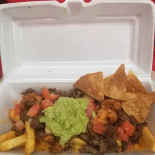 Lil D's Surf &amp; Turf 1/2  Served with. Carne Asada Shrimp Fries Beans Pico de Gallo Topped with Tomatoes Guacamole Chips.