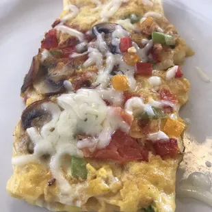 Veggie omelet with a fluffy pancake.