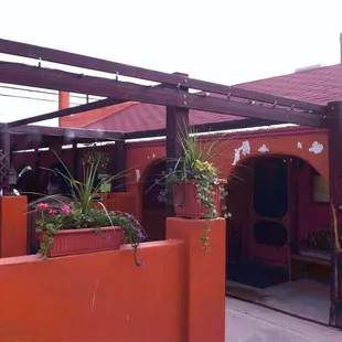 a patio with a pergolated roof