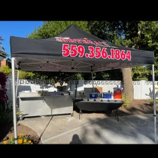 a taqueria tent in a backyard