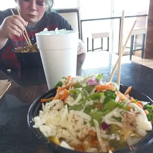 a woman eating a bowl of food
