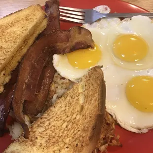 bacon, eggs, and toast on a red plate