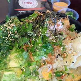 Tofu, avocado, cilantro, corn, Hawaiian Seaweed Salad, avocado, green onion, wasabi (on the side), ginger, Krab meat, sesame seeds
