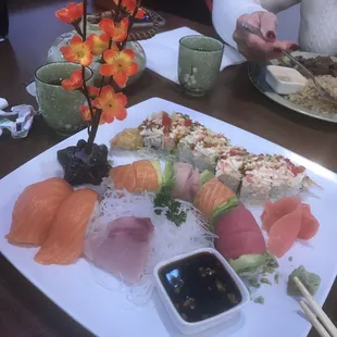 a plate of sushi with chopsticks